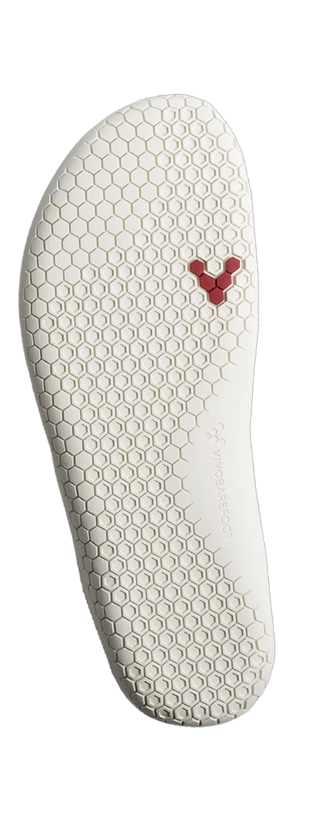 Sål af Vivobarefoot Primus Lite Knit til kvinder, viser miljøvenlig, fleksibel design med sekskantet mønster for bedre greb, subtilt mærke og rødt logo nær hælen, ideel til barfodsløb.